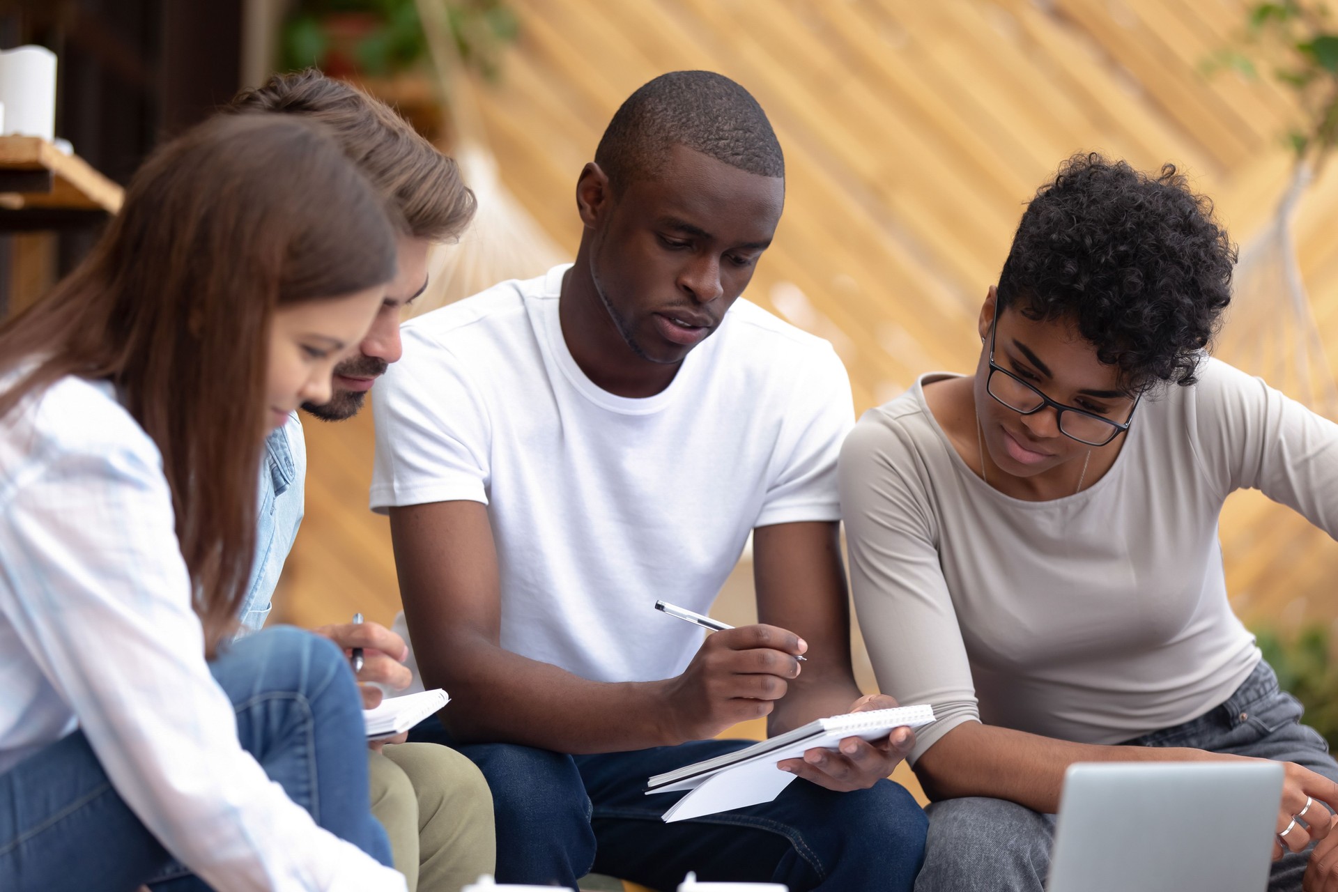 Smart students learning together sitting in cozy place